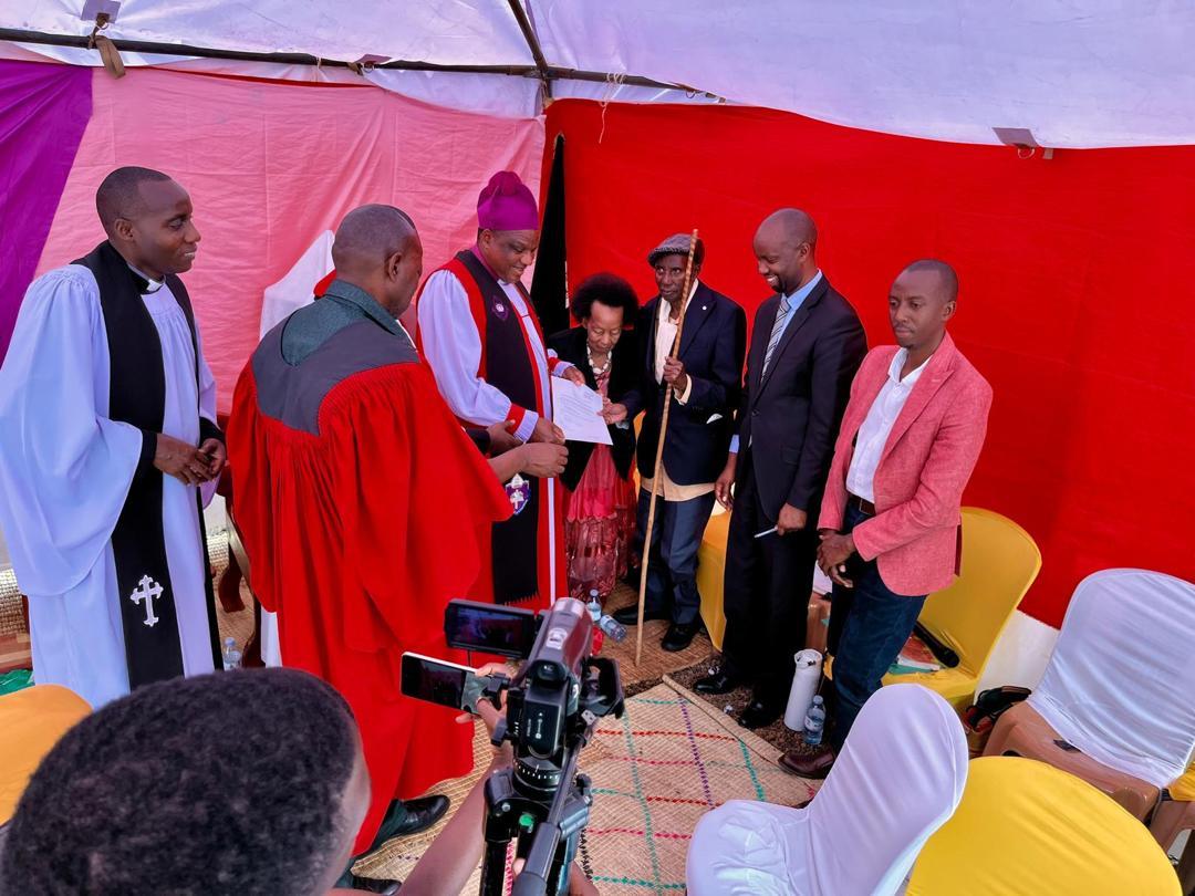 The family of John Gahuriro hands over the land title to Muhabura Diocese. Photo by Muhabura Diocese.